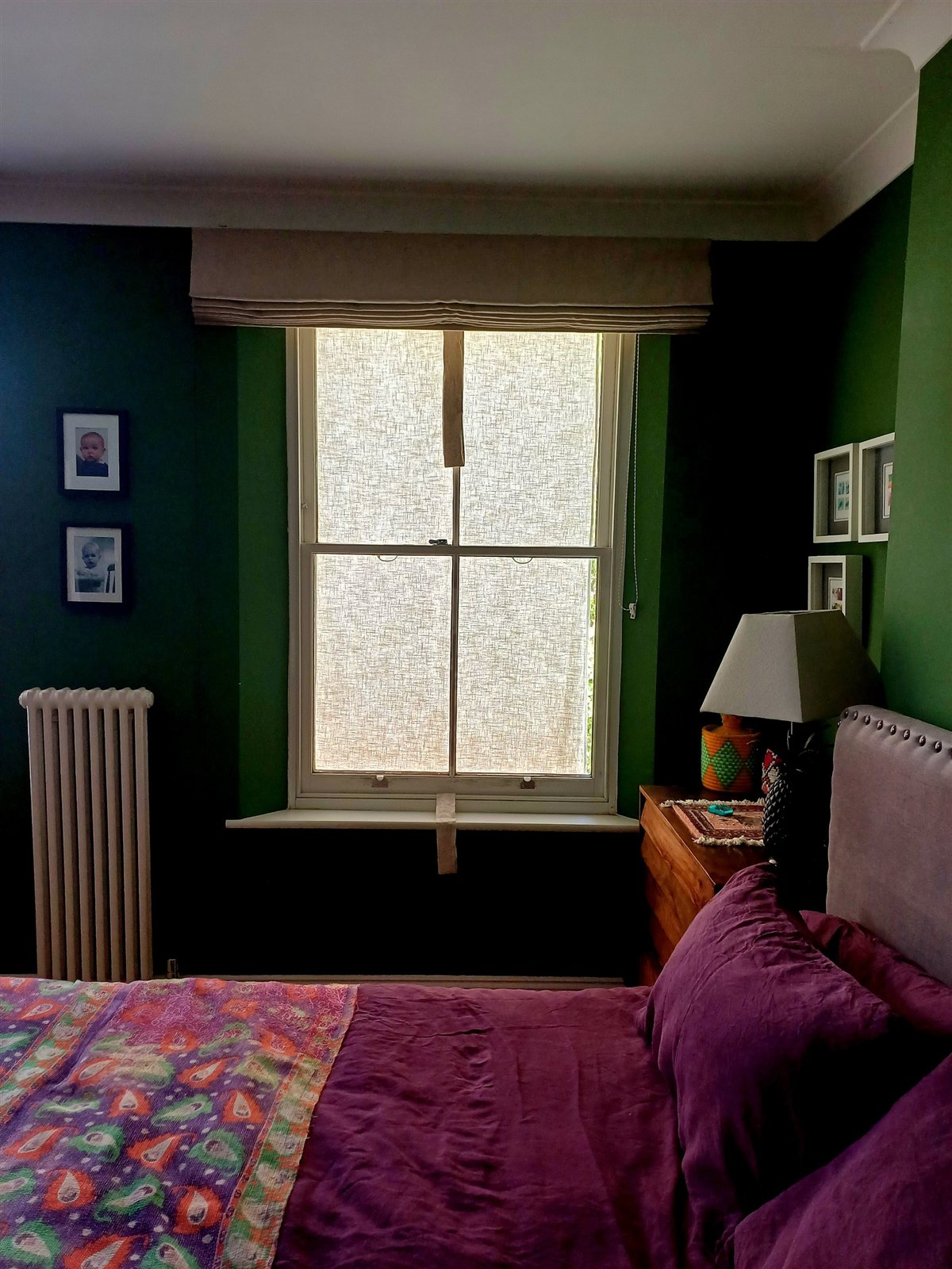 Sash window closed with the linen shade covering the whole window from the outside.