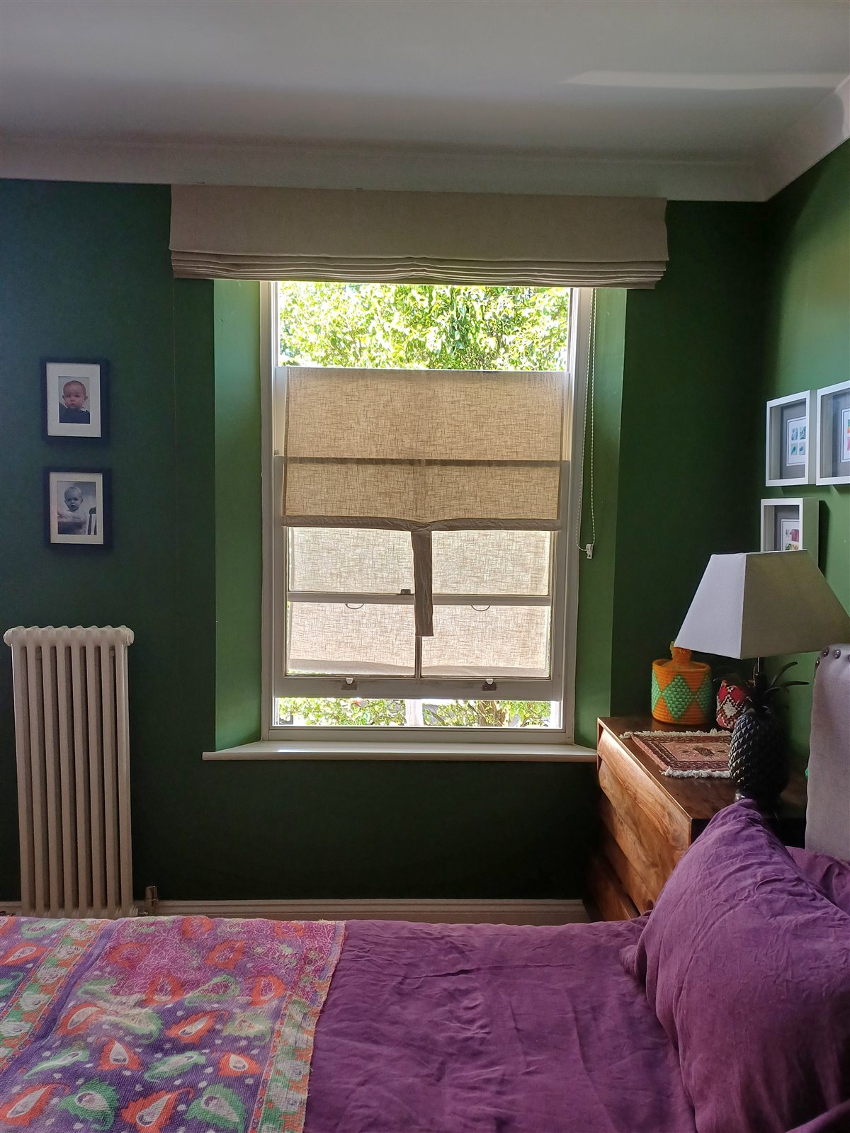 Sashes cracked open with the linen shade still covering the glass, letting cooler air flow through.